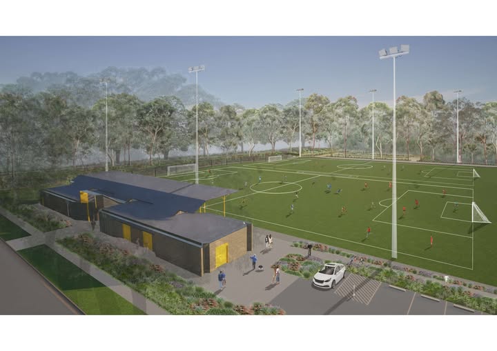 Artist's impression of new community sports fields featuring floodlit soccer pitches, modern amenities building and landscaped entry surrounded by bushland